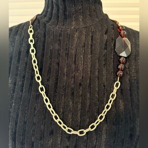 Gold chain and brown ribbon tortoise or amber necklace